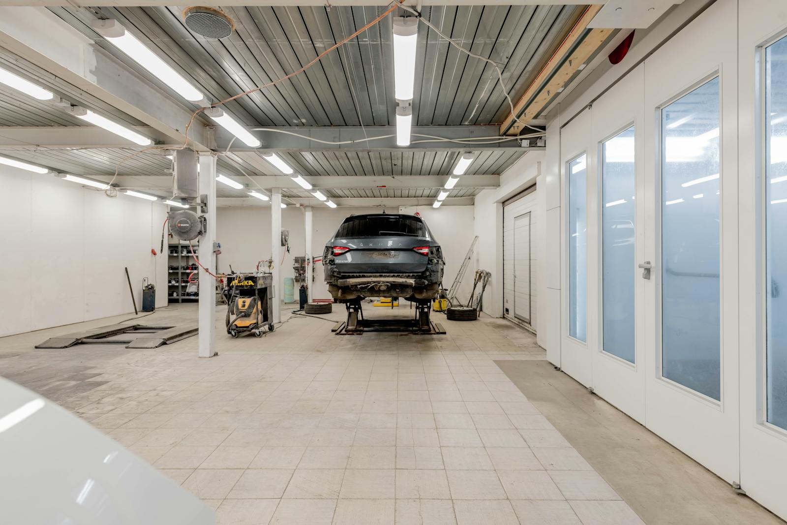 Modern automobile workshop with a vehicle on a lift