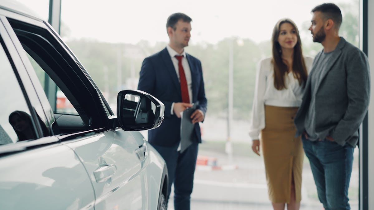 Dealership consultation beside a vehicle