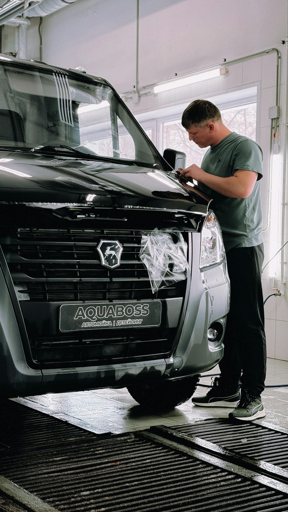 Workshop technician working on a vehicle front assembly